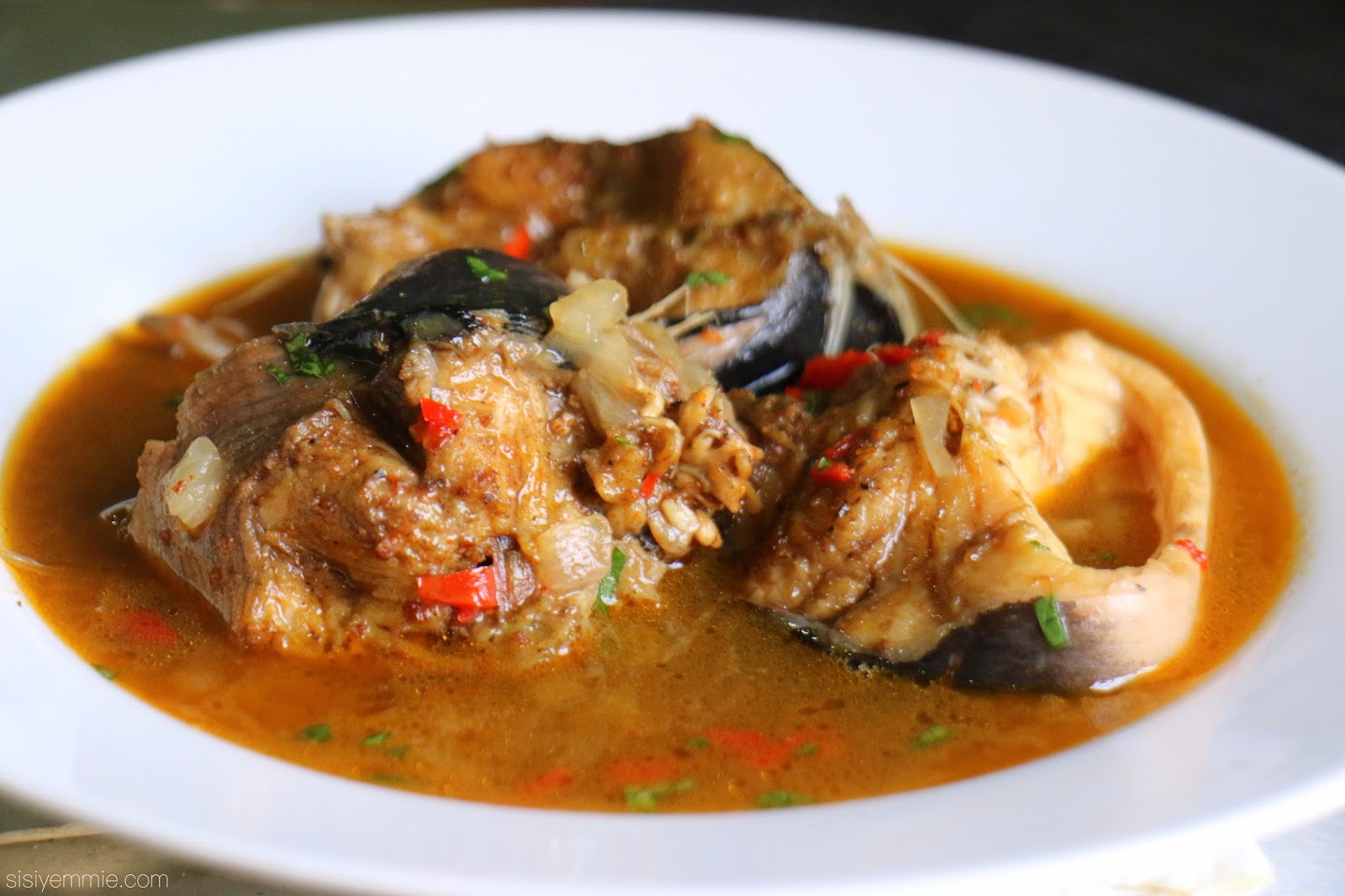 Plated peppered catfish with peppers and onions